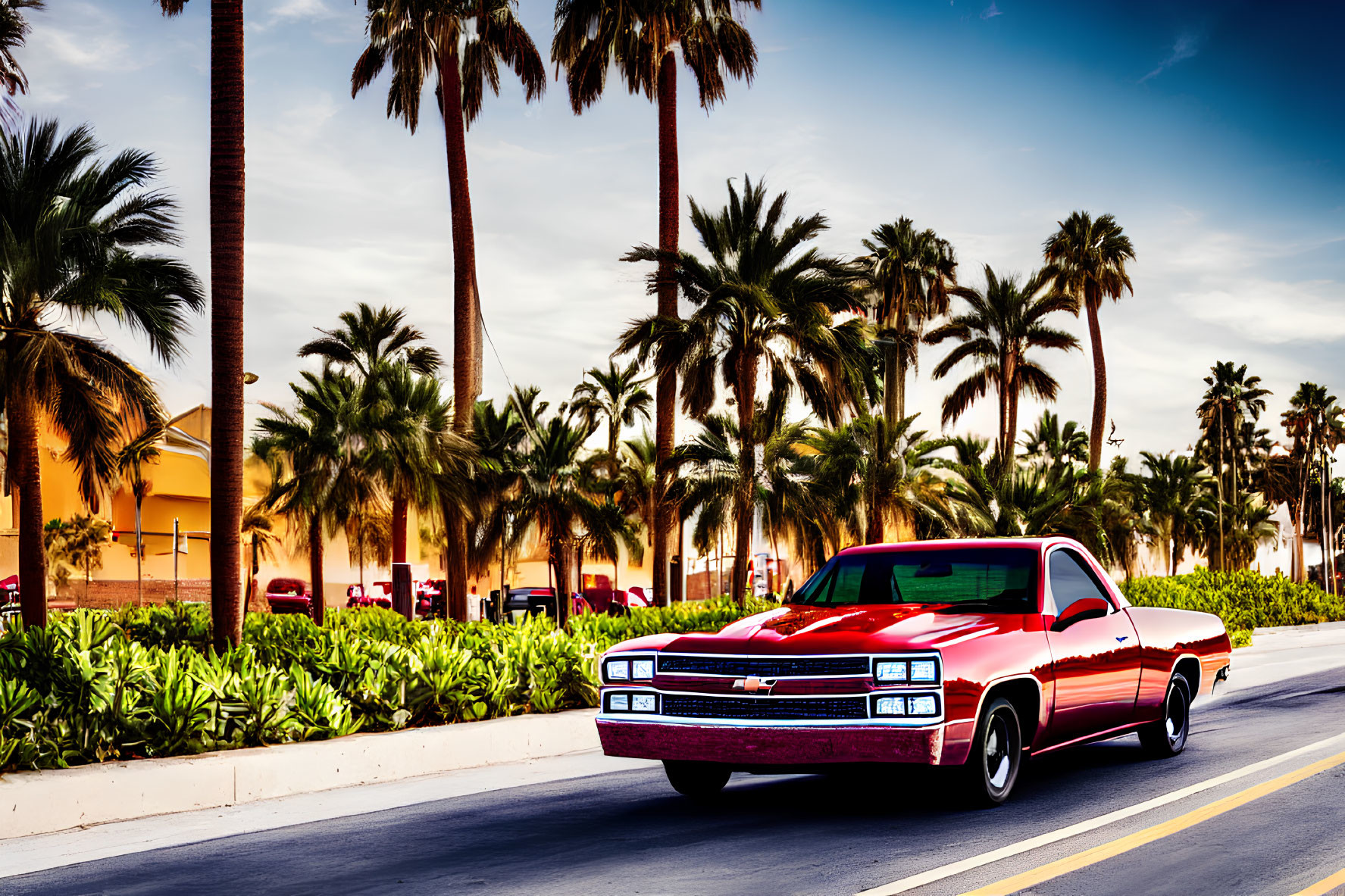 Vintage red car driving on sunny palm-lined street.