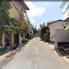 Traditional Village Street with Greenery and Blue Sky in Realistic Style