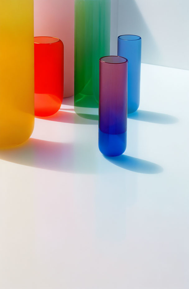 Vibrant translucent cylinders casting colorful shadows