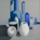 Assortment of Blue and White Reflective Vases on Light Surface