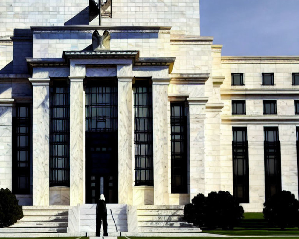 Grand white marble building with pillars, flag, and sculpted eagle.