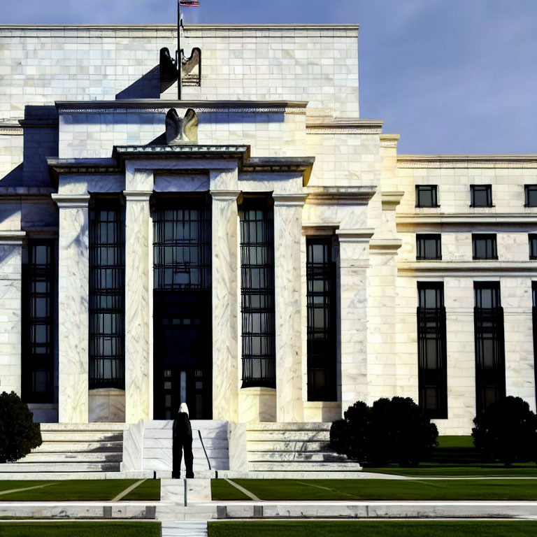 Grand white marble building with pillars, flag, and sculpted eagle.