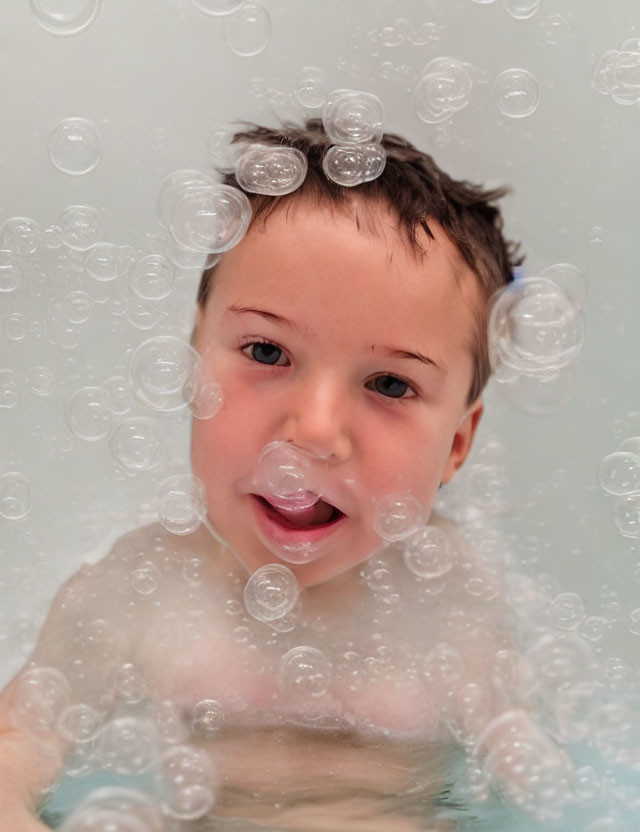 Child Bathing Surrounded by Soap Bubbles