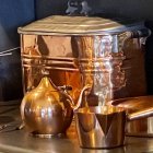 Polished Copper Cookware Set with Pot, Pan, and Lid in Warm Light