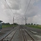 Parallel Train Approaching Under Vast Sky