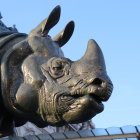 Intricate mechanized rhinoceros against cloudy sky