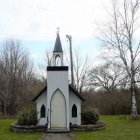 Chapel surrounded by flowering trees and colorful gardens