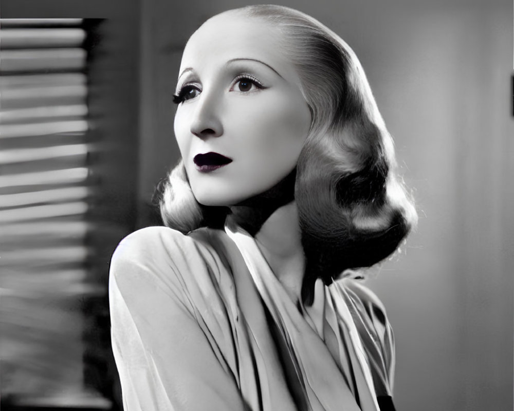 Vintage-style black and white portrait of a woman with elegant dress and makeup