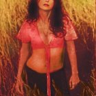 Dark-Haired Woman in Pink Blouse Among Golden Grasses