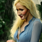 Blonde woman smiling under rain umbrella