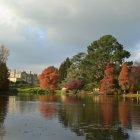 Vibrant red and yellow autumn trees reflected in tranquil lake