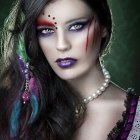 Colorful Makeup Woman Poses with Fantasy Headdress and Ornate Glove