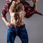 Muscular man in plaid shirt and jeans with baseball bat