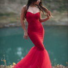 Woman in Red Dress with Feathered Shoulders in Jungle Setting