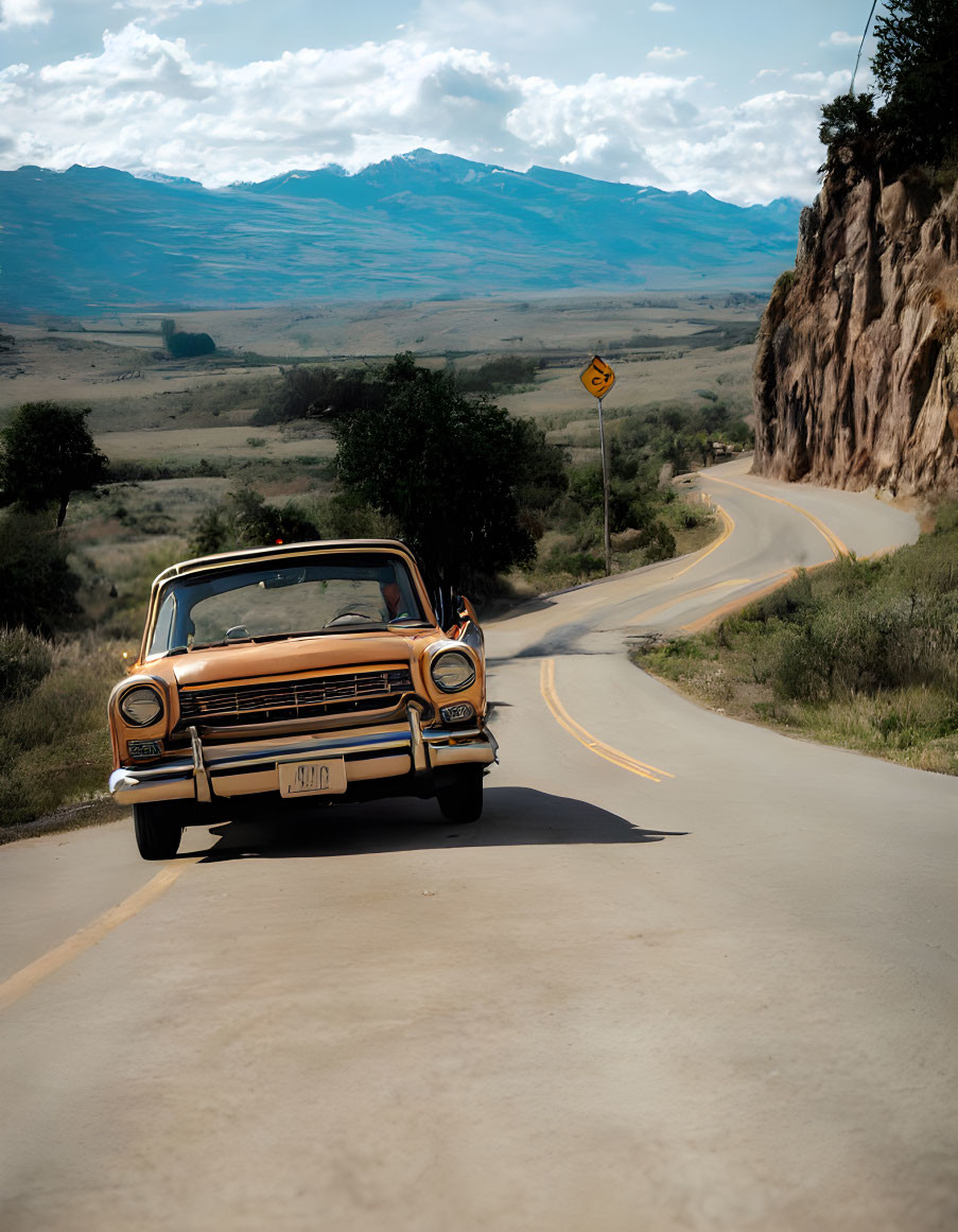 Vintage Car Parked on Winding Road with Mountain Background