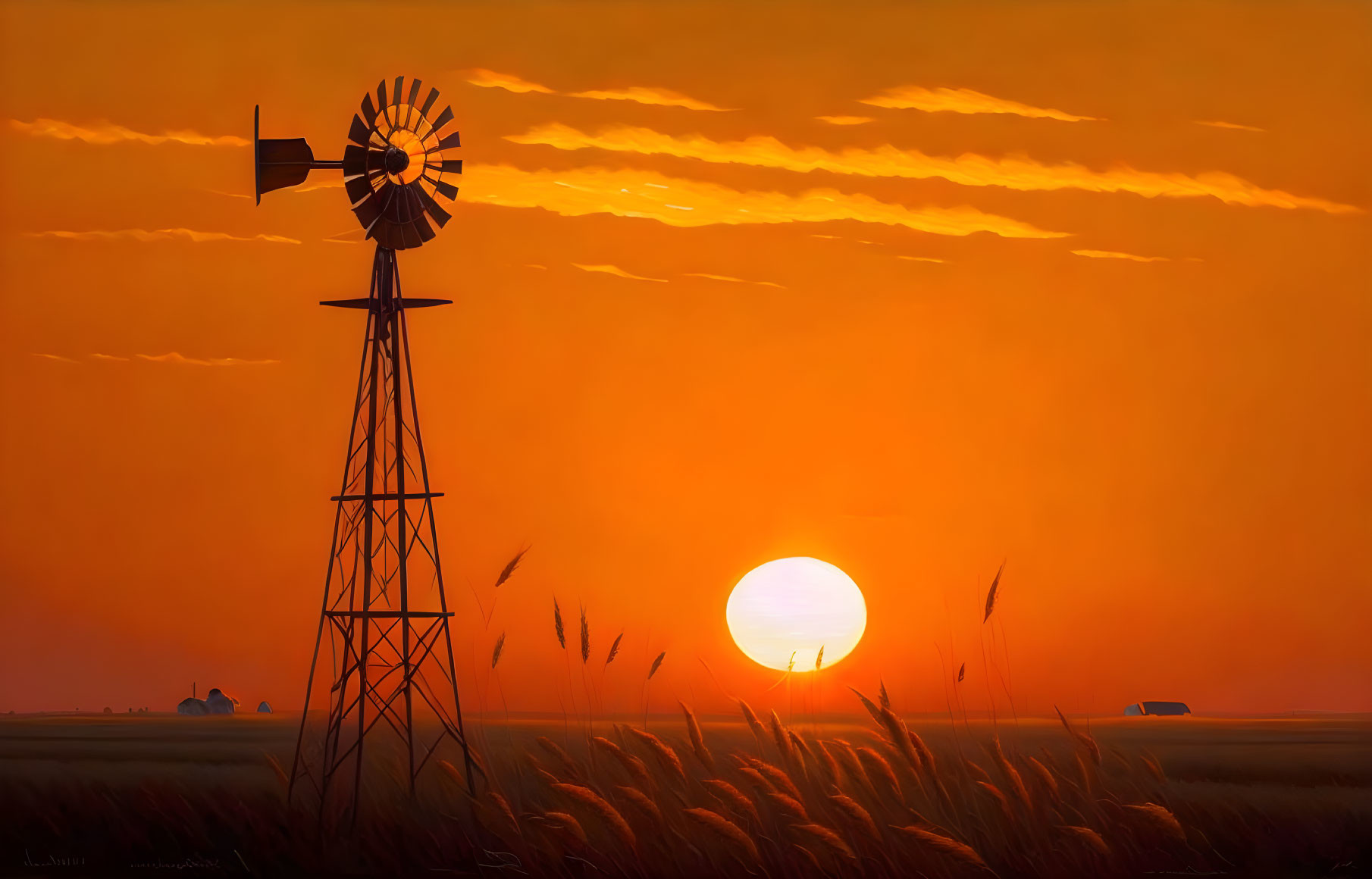 Windmill in field with tall grass at sunset with deep orange skies