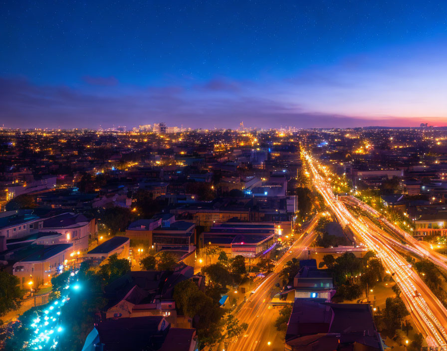 Cityscape at Twilight: Stars, Street Lights, and Illuminated Buildings