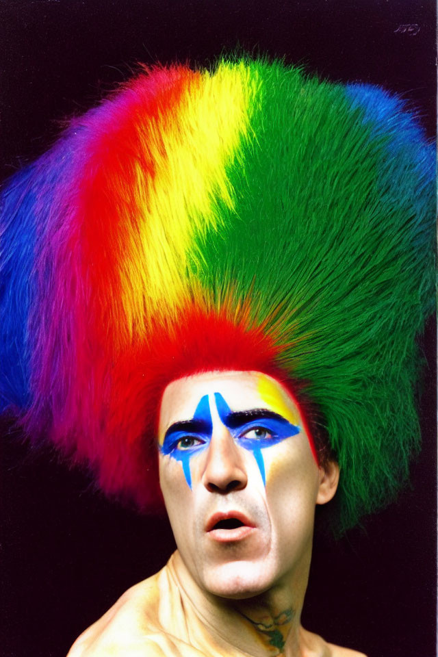 Vibrant rainbow mohawk and blue face paint portrait