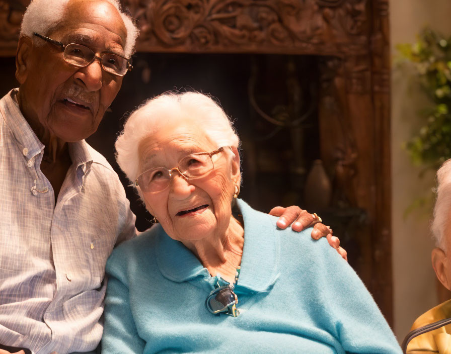 Elderly Couple Smiling Together in Striped Shirt and Blue Sweater