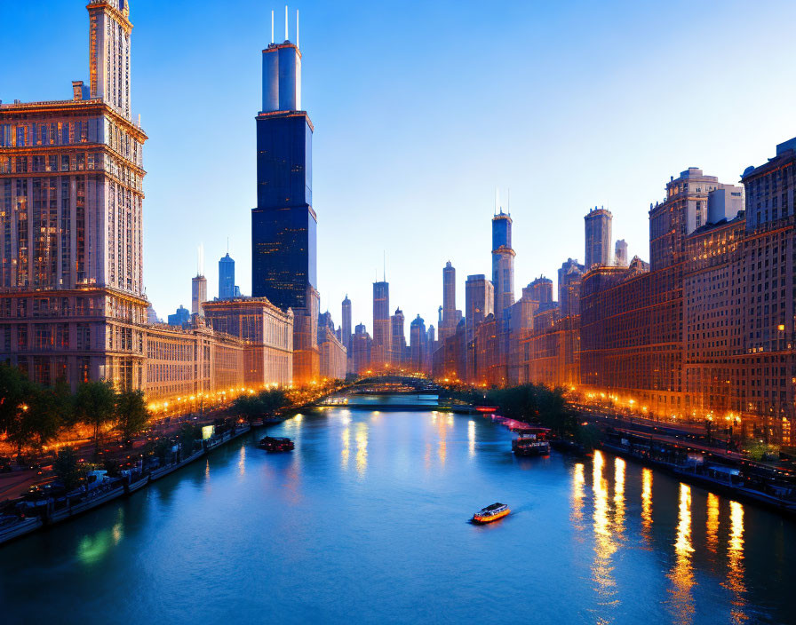 Cityscape with illuminated buildings, river, boat, and clear sky.