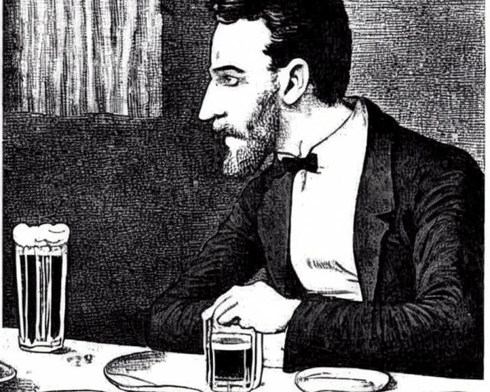 Bearded man in profile view at table with beer and empty plate