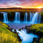 Scenic waterfall at sunset with lush greenery & wildflowers