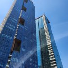 Colorful high-rise buildings against blue sky with white clouds.