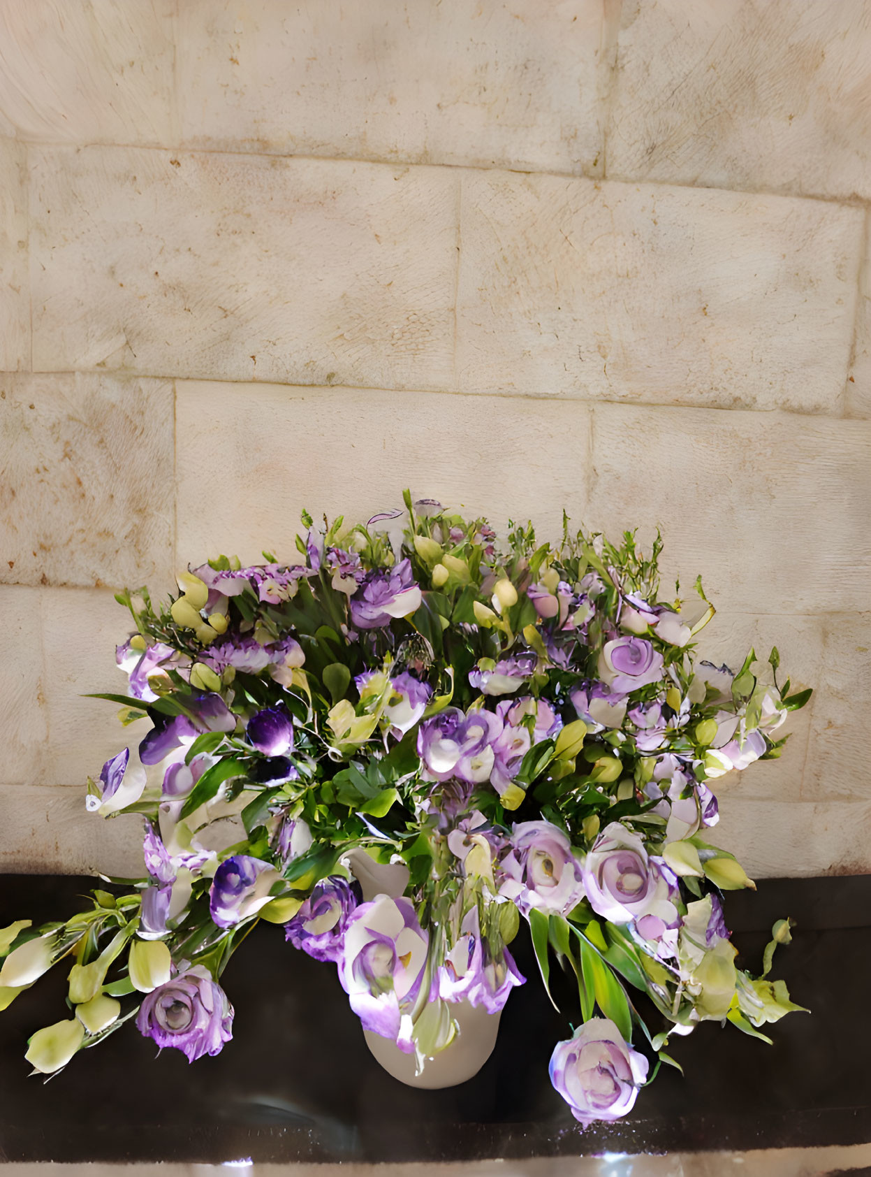 Purple and White Floral Arrangement in White Vase on Beige Tiled Wall