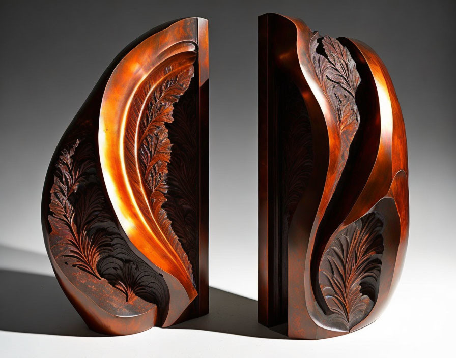 Feather Motif Copper-Tone Bookends on Gray Gradient Background