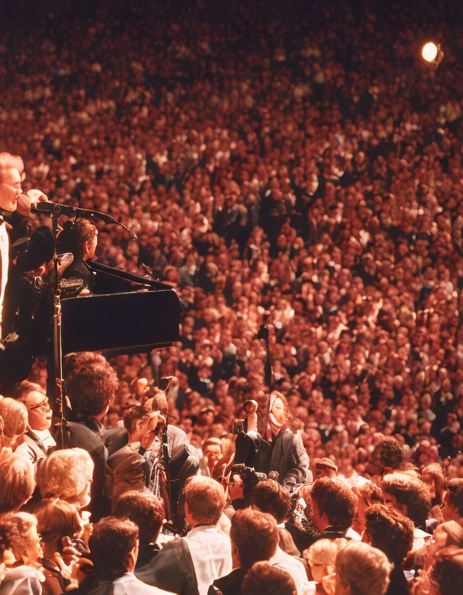 Musician playing grand piano surrounded by orchestra in large venue