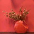 Coral Textured Vase with Pink Grasses on Coral Wall