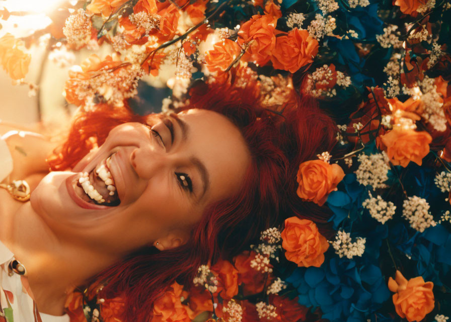 Red-haired woman laughing in vibrant flower garden under sunlight