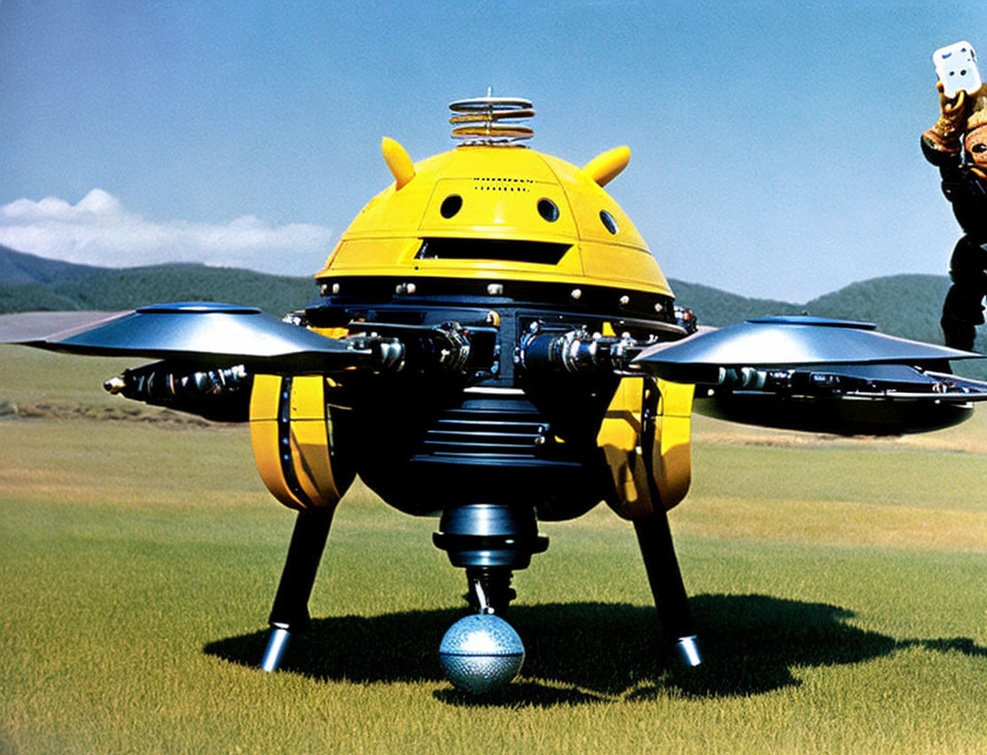 Yellow multi-propeller drone with person on grass field