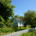 Whimsical cottage in lush gardens with fantastical trees