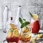 Colorful Beverages in Carafes with Mint and Citrus Slices on Tray