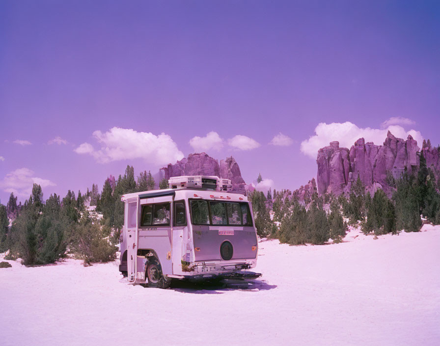 Vintage White Bus on Snow-Covered Landscape with Rocky Cliffs