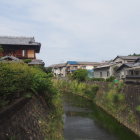 Traditional multi-story wooden houses in serene village by river and mountains