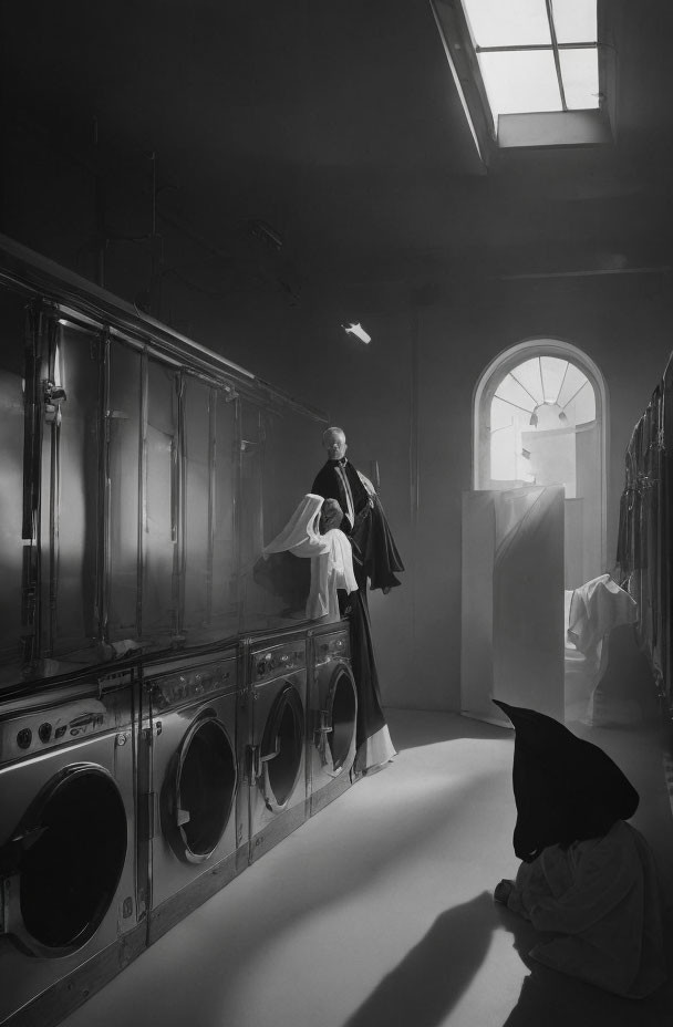 Person in Dark Costume on Washing Machines in Laundromat