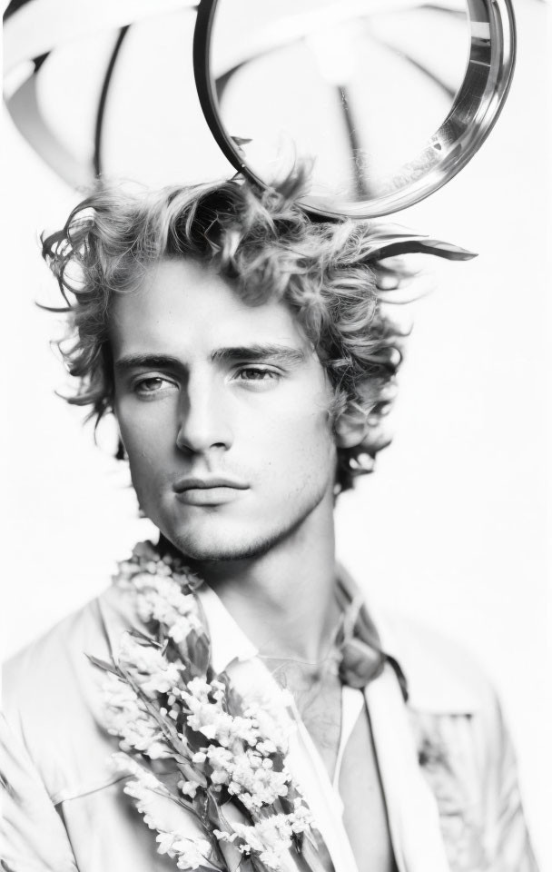 Young man with wavy hair and antlers in floral suit - Black and white portrait