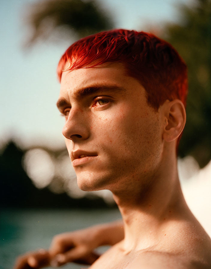 Red-haired person portrait against blurred nature background