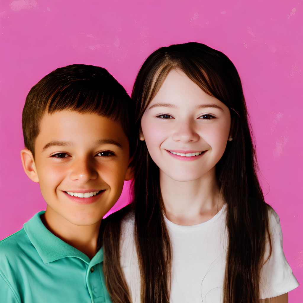 Smiling children in green and white shirts on pink background