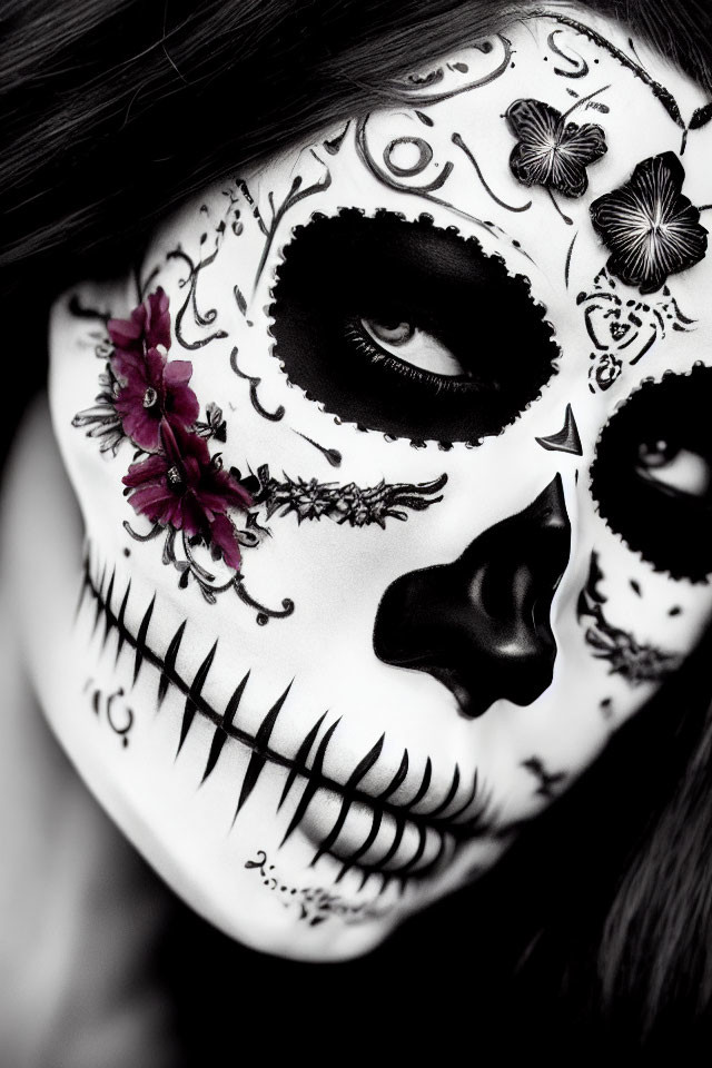 Detailed skull face paint with floral and butterfly motifs for Day of the Dead.