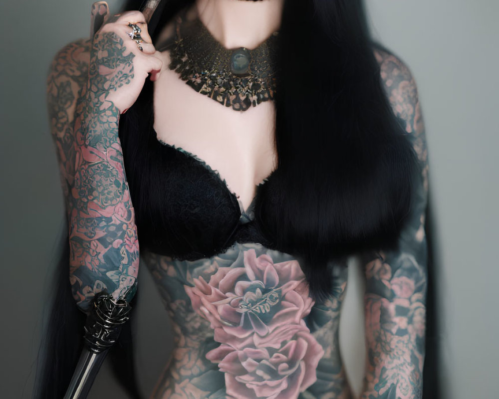 Intricately tattooed person in dark choker and lace attire holding makeup brush