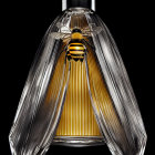 Luxurious Bee Design Perfume Bottle on Reflective Black Surface