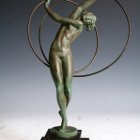 Bronze sculpture of muscular female figure on rectangular base