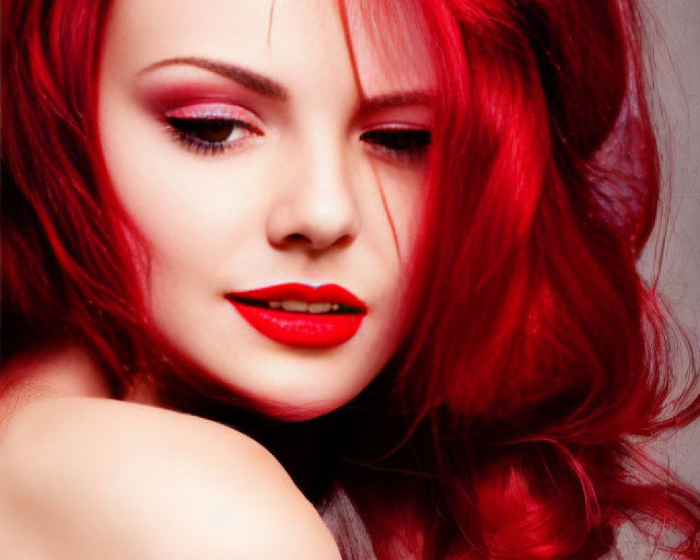 Woman with Vibrant Red Hair and Lipstick Posing Against Red Backdrop