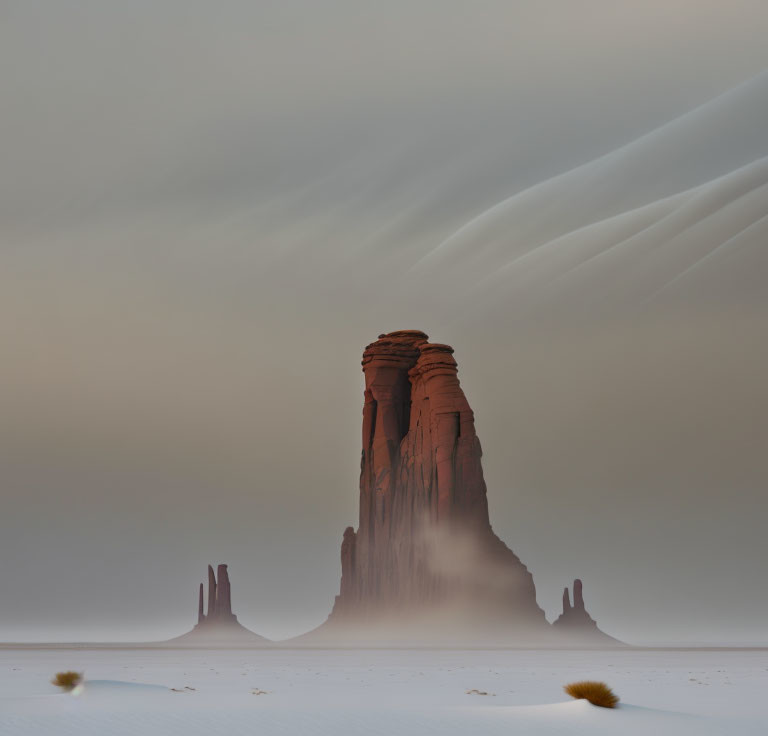 Mystical landscape with towering rock formation in mist