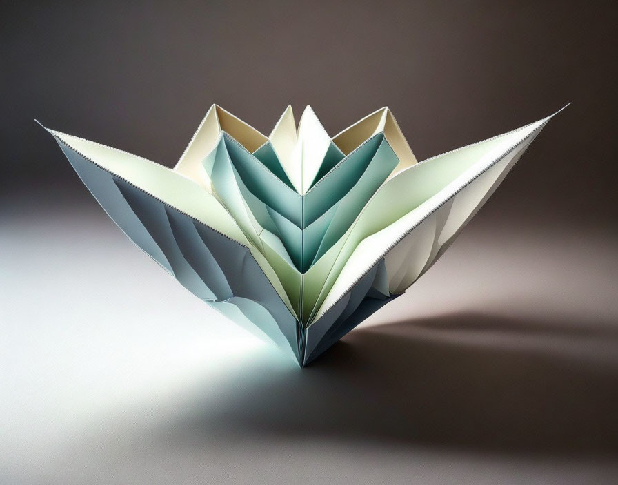 Intricate Origami Flower with White and Blue Petals on Gray Background