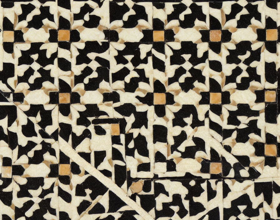 Detailed close-up of beige, black, and brown mosaic pattern on surface