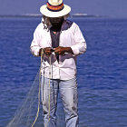 Person in White Suit and Hat with Cane on Blue Background, Stylish Artwork